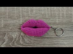 a crocheted keychain with a pink lip hanging from it's side