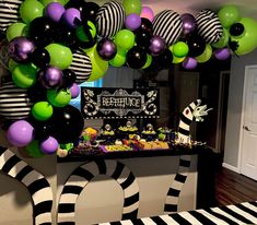 a party with black, white and green balloons