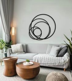 a living room filled with furniture and a large circular metal wall art above the couch