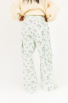 these trendy floral cargo pants are a must-have for any casual summer // spring outfit idea. detailed with a vintage-inspired ditsy floral pattern, these mint cargo pants feature a drawstring waist + chic pouch pockets. the perfect statement bottoms to dress up or down, season after season. mint // wide leg, one button fly zip, adjustable tie waist, belt loops, pockets, adjustable tie hem paired with our melody sweater model is 5'8" + wearing a small measurements are approximate + taken while la Spring Outfit Idea, Ditsy Floral Pattern, Floral Pant, Pants Large, Ditsy Floral, Outfit Idea, Waist Belt, Spring Outfit, Garden Party