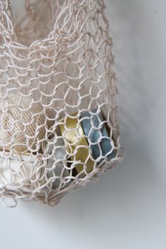 a white net bag filled with assorted items