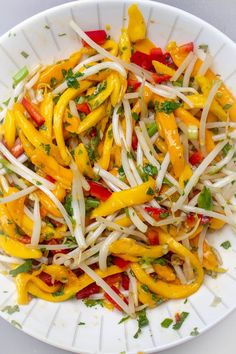 a white plate topped with yellow and red peppers