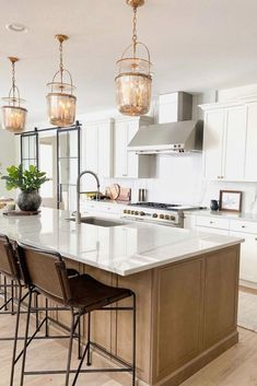 a large kitchen with an island in the middle and lots of chairs at the counter