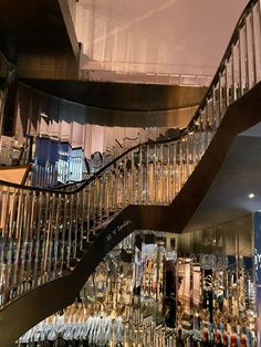 a spiral staircase in a building with glass balconies on the top and bottom