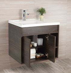 a bathroom sink sitting next to a wooden cabinet