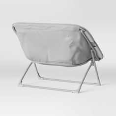 a chair that is sitting on top of a metal frame with the seat folded down