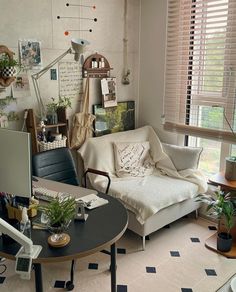 a living room filled with furniture and lots of plants