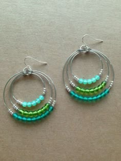 two hoop earrings with green and blue beads