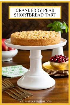 cranberry pear shortbread tart on a white cake stand