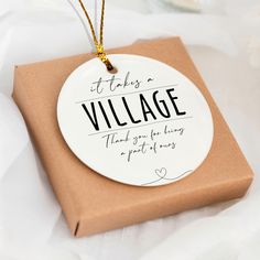 a gift wrapped in brown paper with the words it takes a village