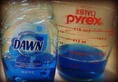 two bottles of dawn water sitting next to each other on a counter top with measuring cups in front of them