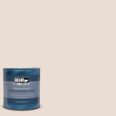 the behr paint is light beige and has a green tint with white lettering on it