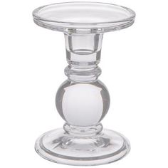 a clear glass candle holder with a ball on the top and bottom, sitting in front of a white background