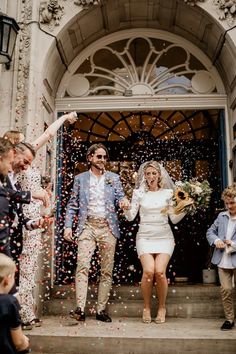 a newly married couple exiting the church with confetti thrown in front of them