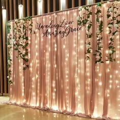 the wedding backdrop is decorated with white flowers and greenery