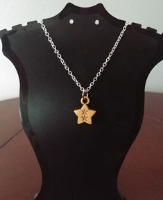 UP FOR BID IS A WOMAN'S FASHION CARVED STAR NECKLACE. BEIGE STAR PENDANT/CHARM WITH TWO CARVED STARS INSIDE. 18" SILVER TONE CABLE LINK NECKLACE WITH LOBSTER CLASP CLOSURE. SMALL STAR PENDANT MEASURES .50" X .75"  NO INTERNATIONAL SHIPPING. Silver Chain Pendant, Celestial Necklace, Woman's Fashion, Chain Pendant, Silver Chain Necklace, Fashion Jewelry Necklaces, Star Pendant, Star Charms, Star Necklace