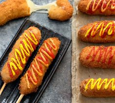 several hot dogs with ketchup and mustard on them