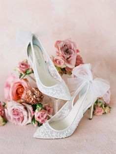 wedding shoes and bouquet on pink background