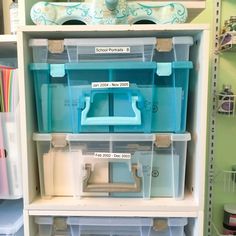 the shelves are filled with plastic containers and storage bins for crafting or sewing