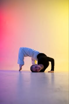 a woman is doing a yoga pose on the floor