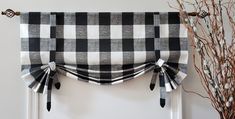 a black and white checkered window valance hanging on the side of a wall