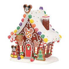 a gingerbread house with mickey mouse on top