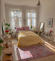 a bed sitting in a bedroom next to a window filled with lots of plants and furniture