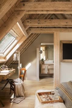 an attic bedroom with wood floors and exposed rafting on the ceiling, along with a bed