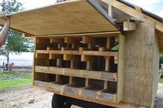 a man is holding onto the side of a truck with lots of wooden pallets