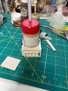 a red light sitting on top of a green cutting board