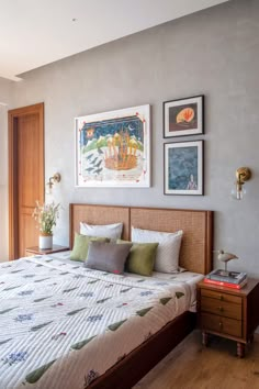 a bedroom with a bed and pictures on the wall