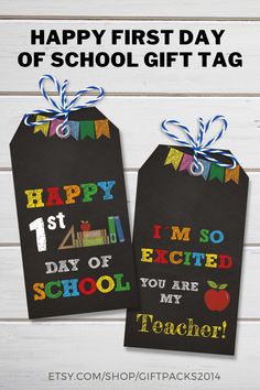 two back to school gift tags with the words happy first day of school on them