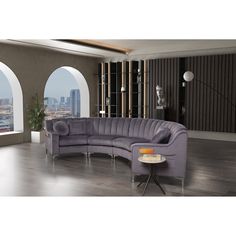 a purple couch sitting in front of an arched window