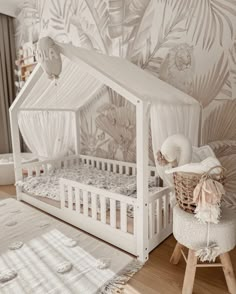 a baby's room with a white crib and bed