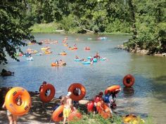 many people are in the water with rafts