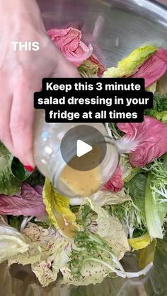 someone pouring dressing into a salad in a bowl with lettuce and other vegetables