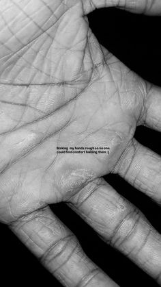 a black and white photo of a person's hand with the words making up human rights is not easy