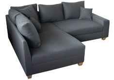 a gray couch with pillows on top of it