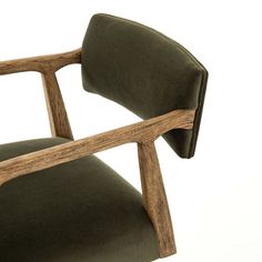 a wooden chair with green upholstered fabric