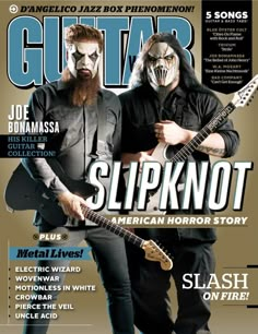 the cover of guitar magazine with two men in masks playing guitars and one is holding an electric