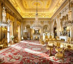 an ornately decorated room with chandeliers, chairs and rugs on the floor