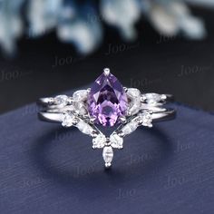 1.25ct Pear Shaped Natural Amethyst Ring Set Silver Platinum Purple Crystal Amethyst Wedding Bridal Ring February Birthstone Jewelry Gifts 30 days non-hassle return policy. For returned items, there may be handcrafting and shipping fee deducted.  DETAILS: - Material : 925 Sterling Silver (Hypoallergenic, Nickel Free, Tarnish Resistant)Solid 14k/18k gold,platinum PLEASE choose silver or platinum if you are allergic to nickel. - Main stone : 6*8mm pear cut natural amethyst - Accent Stone : Simulated Diamonds - Stone Cut : pear ACCEPT CUSTOM SERVICE: 1. Accept engrave the words inside the ring.  2. Accept change main stone type 3. Accept change other material : This jewelry can also be made in solid gold (including 10/14/18k white/rose/yellow gold...), platinum Please contact me if you have s Purple Crystal Ring, Wedding Purple And Silver, Diamond And Amethyst Wedding Ring, Purple And Silver Jewelry, Purple Wedding Rings Set, Purple Engagement Ring Silver, Amethyst Engagement Ring Silver, Amethyst Engagement Rings, Purple Wedding Rings