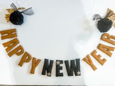 a happy new year banner made out of pretzels and black pom poms