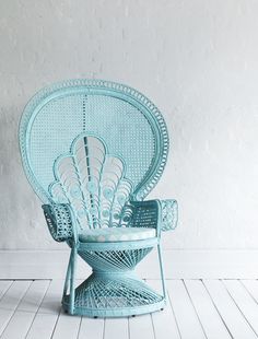 a blue chair sitting on top of a white floor