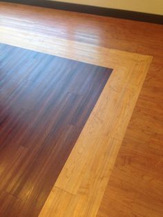 an empty room with wooden floors and hard wood flooring on the floor, in front of a window