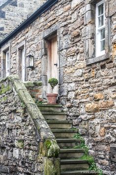 an old stone building with steps leading up to it