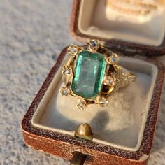 RING SIZE:   8 1/2US, 58 EU [FREE RESIZING] GOLD: 18 k WEIGHT: 5.3 grams STONES: emerald, diamonds EMERALD: 3 ct.  DIAMONDS TOTAL WEIGHT: 0.03ct CUT: rose cut CONDITION: EXCELLENT Beautiful, dainty emerald and diamond Victorian ring from the 1870s with Hungarian import hallmarks from 1867-1922. The emerald is around 3 ct. and has a bright, deep green color and it also features 0.03 ct. rose cut diamonds. The gold has skilfully hand carved designs on it. The ring weighs 5.3 grams, and is size 8 1 Luxury Vintage Emerald Ring With Intricate Design, Vintage Emerald Gold Ring, Emerald Rings Vintage, Victorian Emerald Ring, Antique Emerald Ring Vintage, Gold Emerald Rings, Vintage Engraved Emerald Ring, Vintage Rings Antiques, Engagement Ring Gold Emerald