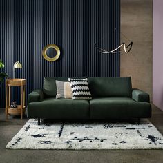 a living room filled with furniture next to a wall covered in blue and white stripes