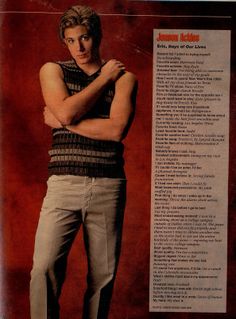 a man standing with his arms crossed in front of a magazine advertisement for men's health