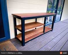 a wooden table sitting on top of a porch